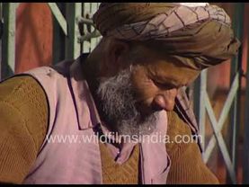 Afghani women visit a cobbler in Kabul, Afganistan, to get their shoes fixed