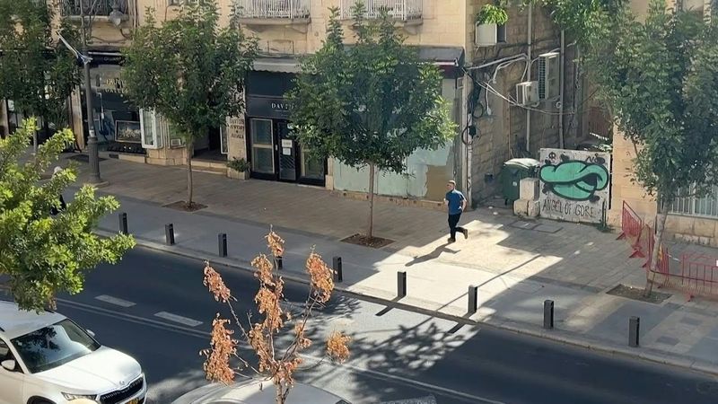 People run for cover and air raid sirens sound in Jerusalem following missile from Yemen | AFP