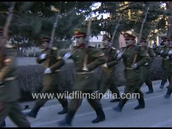 Armed (Russian?) troops march goose-step in military boots at Presidential Palace in Afghanistan
