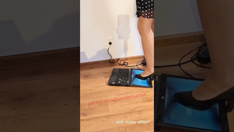 Laptop crushed with black high heels
