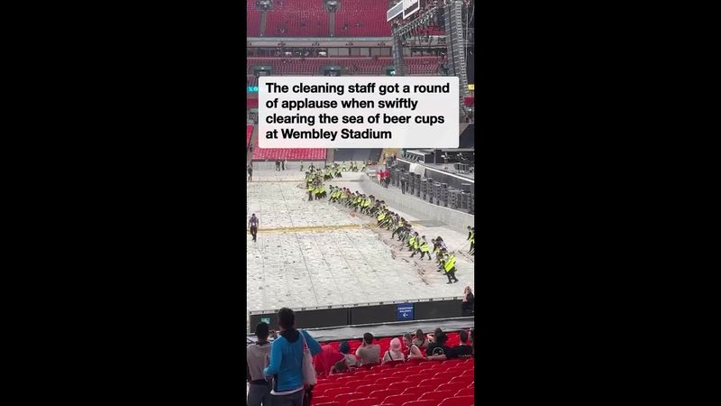 Cleaners create a 'wonderwall' to clear beer cups at oasis concert