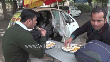 People having food by the roadside, a Nano Car is converted into a Mini Dhaba, New Delhi