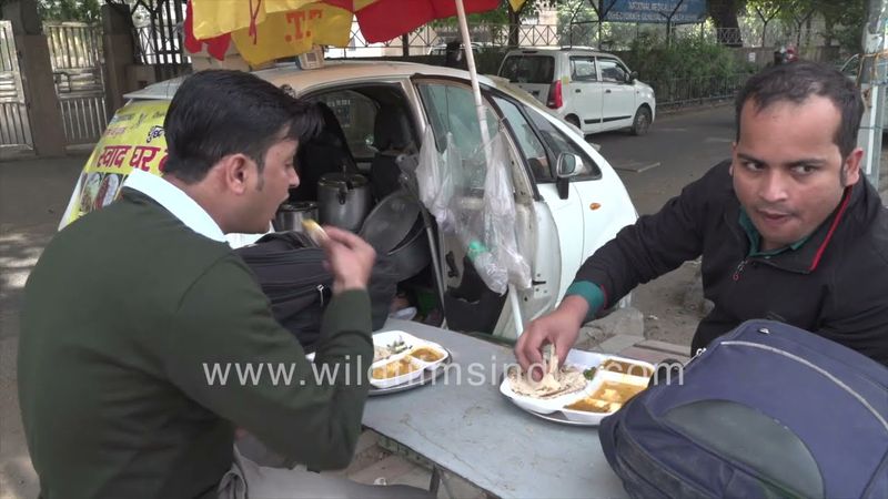 People having food by the roadside, a Nano Car is converted into a Mini Dhaba, New Delhi