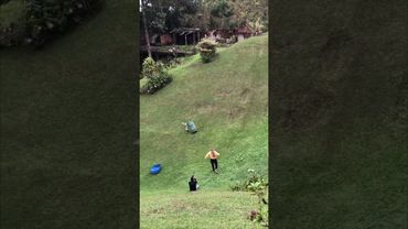 Boy Slides on Plastic Barrel, Flips Over, and Falls Down Hill as Girl Runs to Help