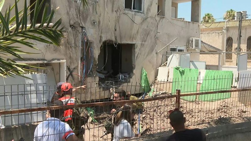 Damage at residential building hit by drone in north Israel | AFP