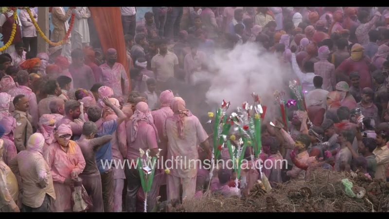 People of Phalain village in white kurta and pyjama playing Holi with gulal before Holika Dahan.