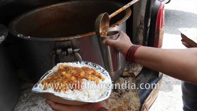 Large dekchis of Chhole Chawal for the poor being distributed at AIIMS crossing in Delhi