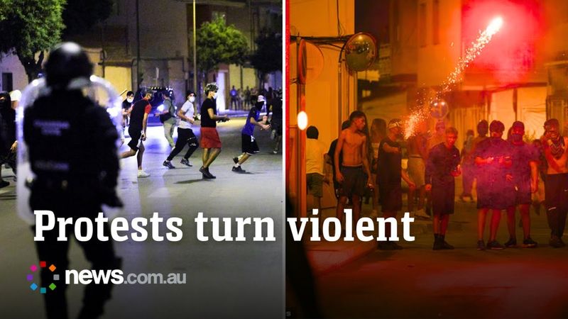 Police clash with protestors after alleged migrant gang bashed elderly man in Spain