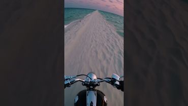 Riding between two oceans under a flamingo-pink sky. Pure freedom. 🏍️🌊💗#POVRide #SandbarDream #Pink