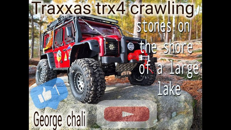RC Traxxas TRX4 crawlings stones on the of shore a large lake