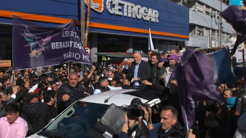 President Milei drives off as protesters throw objects at his vehicle during rally | AFP