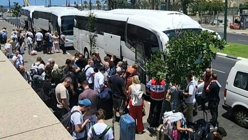 Foreign passport holders board buses in Tel Aviv for evacuation out of Israel | AFP