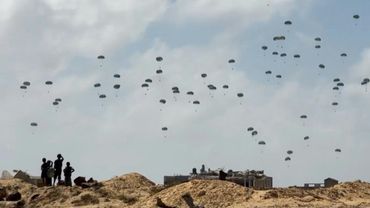Parachutes fall during aid airdrop over the central Gaza Strip | AFP