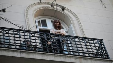 Argentine ex-president Kirchner greets supporters from balcony after Supreme Court decision | AFP