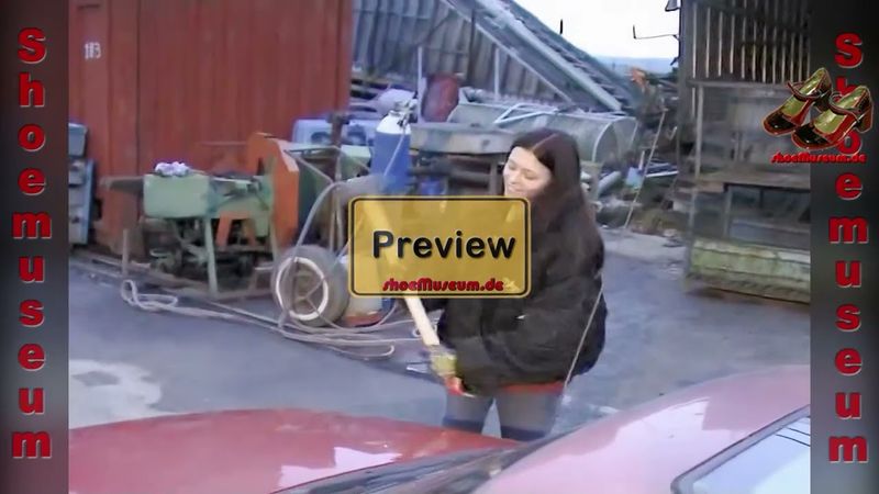 Auto Crush 1 - junge Frau macht ein Auto mit Hammer kaputt