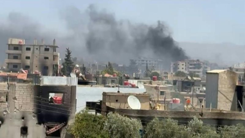 Smoke billows as Syria tribal fighters deploy in Druze village near Sweida | AFP