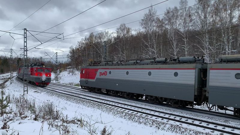 Freight trains in winter. Diesel locomotive and passenger trains