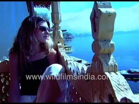 A woman tourism from north India sits on a shikara on Dal Lake in Srinagar, Kashmir of the 1990's