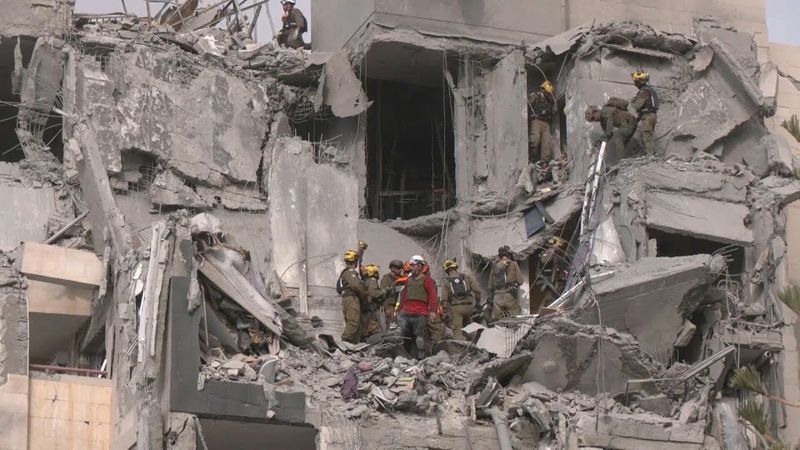 Israel rescuers search rubble of building hit by deadly Iranian strike | AFP