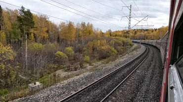 Russia: arrival and departure of a passenger train at Krasnoyarsk railway station | Window view