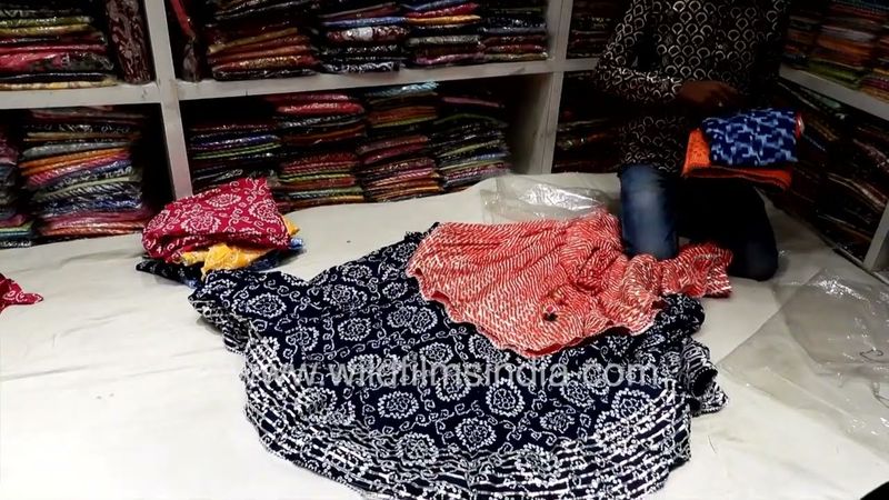 A shopkeeper is selling a Rajasthani print Lehenga Udaipur, Rajasthan