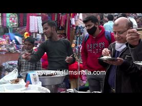 A salesman is selling rabri and kachori near the Jama Masjid of Delhi