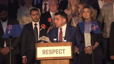 Romania's George Simion arrives for his speech after the election | AFP