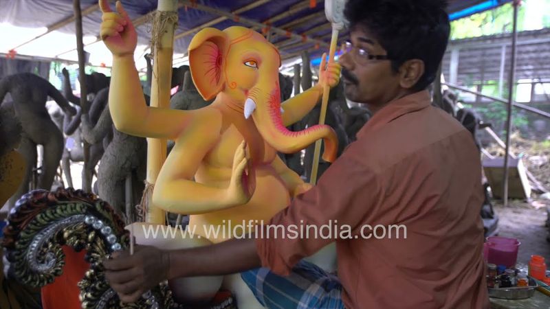 Ganesh Murti is being painted by the sculptor in CR Park before Ganesh Chaturthi in New Delhi