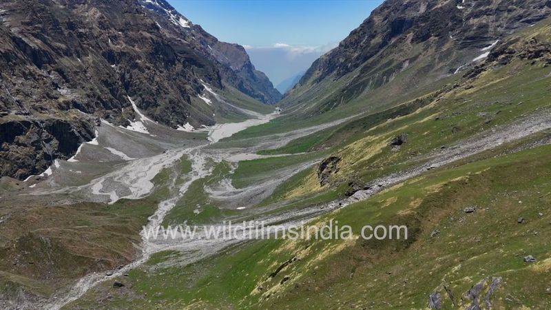 Sweeping across rocky meadowlands below citadel rockface of outer ring of Nanda Devi Sanctuary