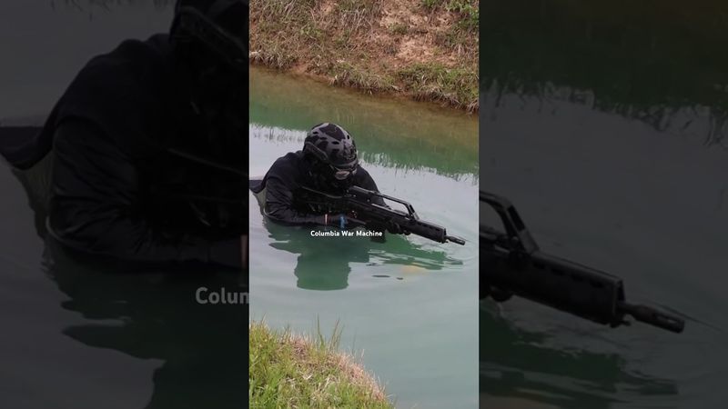 Coming out of the water shooting HK G-36 Machine Gun.                         Columbia War Machine