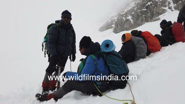 Trekkers take deep snow pit stop while climbing atop Kalindi Khal in Himalaya: 19K feet altitude