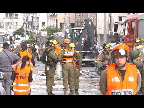 Emergency teams clear rubble at site of Iranian strike near Tel Aviv | AFP