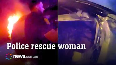 Police officers rescue woman from burning car after crash