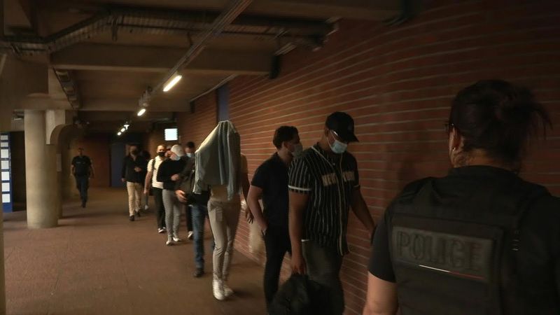 French police officers arrive in court for assault trial | AFP