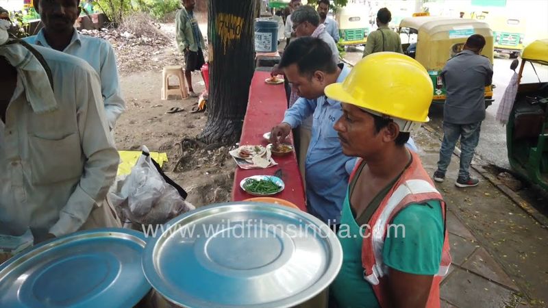 Auto drivers of New Delhi are eating food at a small dhaba near Narojini Nagar