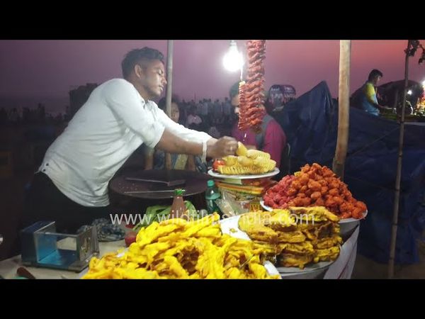 A hot and crispy Tornado potato is being fried in a food cart near Puri Beach Odisha