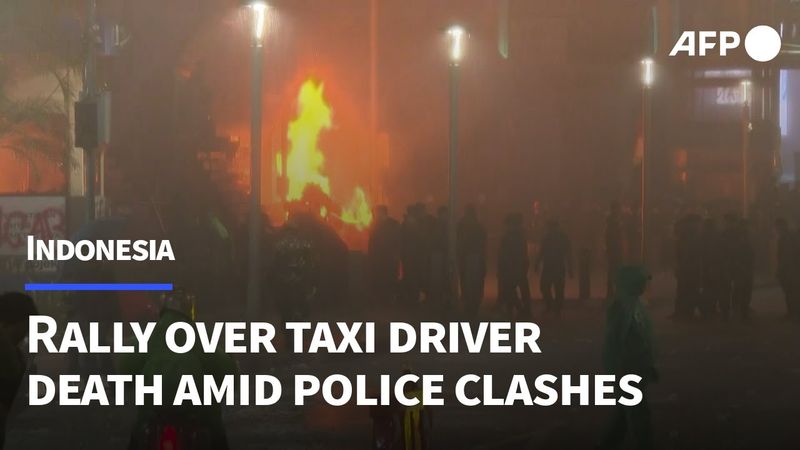 Protesters set fires in Jakarta as they rally over taxi driver's death | AFP