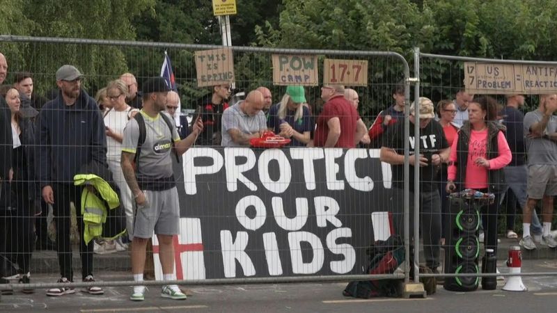 Protesters, police outside UK hotel housing asylum seekers | AFP