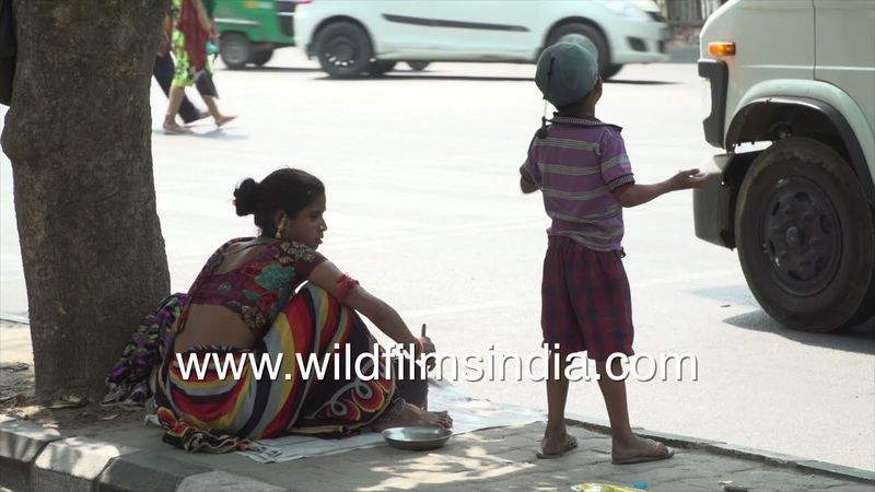 Poor family living on streets of Delhi city: India's poverty goes hand in hand with extreme wealth