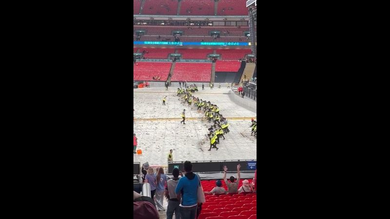 Cleaners create a 'wonderwall' to clear beer cups at oasis concert