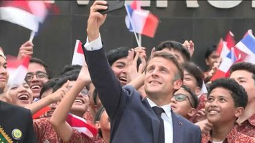 France's Macron takes selfies with students at university in Jakarta | AFP