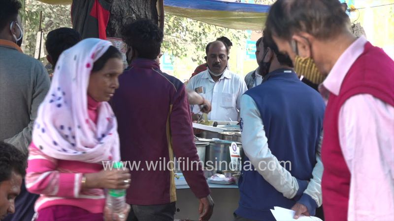 People having lunch in a small roadside dhaba near Bhikaji Cama Place, New Delhi
