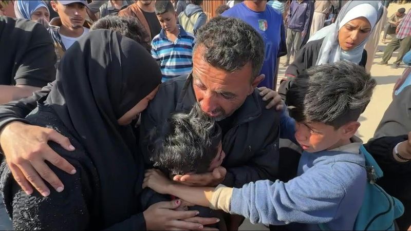 Children mourn their mother killed as she went to collect aid in Gaza | AFP