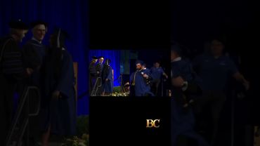 University of Buffalo grad chased by police as he runs across stage holding his baby