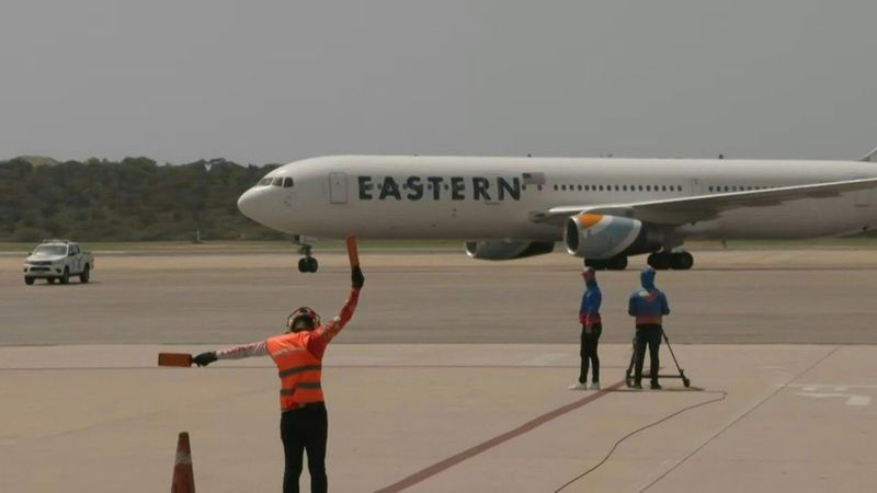 Flight from US with migrants arrives at Caracas airport | AFP