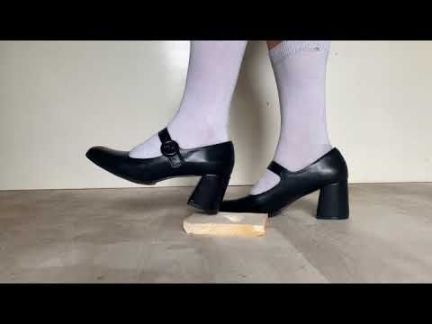Heeled Mary Janes crushes and tramples on bread