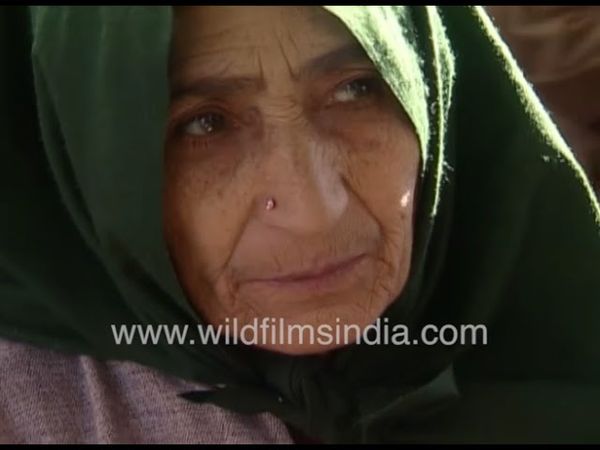 Kashmir women and kids pray at a mosque in Srinagar Kashmir in the 1990's, receive holy offerings