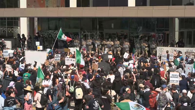 Protesters and National Guard troops gather outside LA Federal Building | AFP