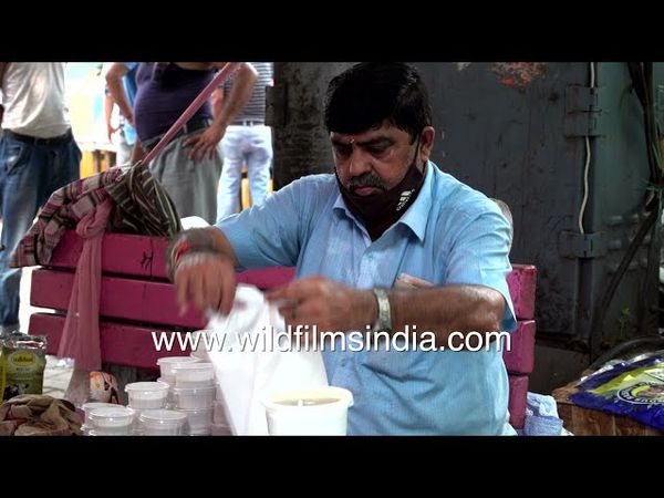 Lunch being packed in a white food container and sold to customers Packing food, Naurojini Nagar