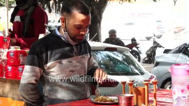 People buying lunch tandoori naan and chole bhature from Om Food Corner New Delhi